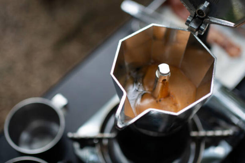 Espresso brewing in a classic moka pot on the stovetop. Espresso brewing in a classic moka pot on the stovetop. moka pot stock pictures, royalty-free photos &amp; images
