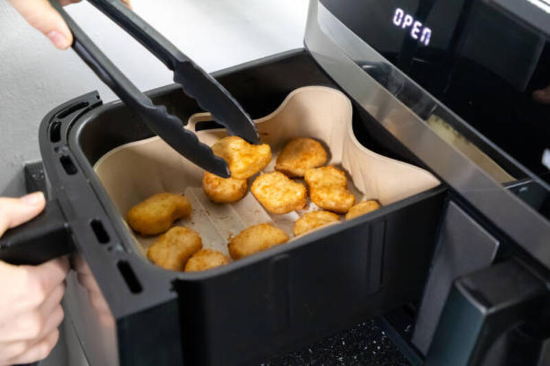 nuggets cooked in an air fryer. cooking in an air fryer. - airfryer potret stok, foto, &amp; gambar bebas royalti