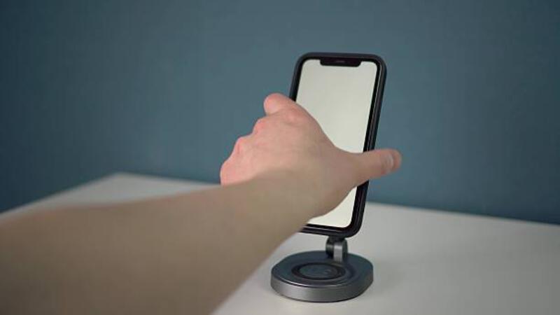 the-phone-is-placed-on-a-magnetic-stand-with-wireless-charging-located-on-a-free-and.jpg (612×344)