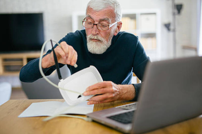 senior-man-trying-to-connect-internet-and-router-on-his-laptop.jpg (612×408)