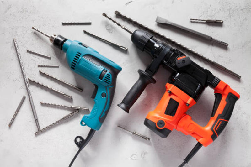 merapatkan bor listrik pada latar belakang beton - bor listrik potret stok, foto, &amp; gambar bebas royalti