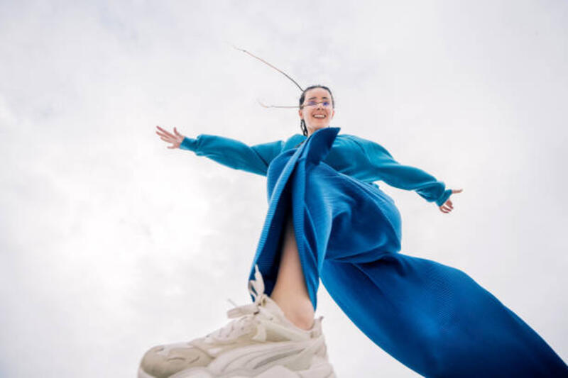 jumping-woman-in-blue-suit-on-the-cloudy-sky-background-low-angle-view.jpg (612×408)