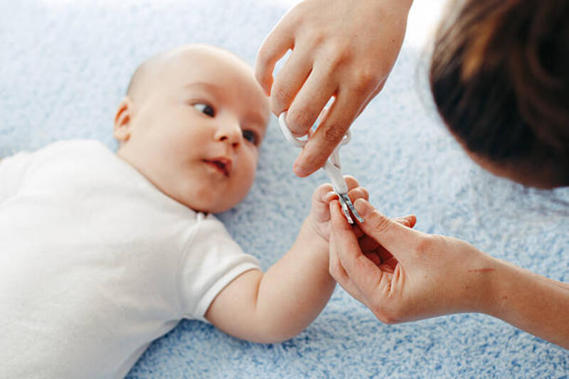 Mother cutting babies nails Mother cutting babies nails trimming nail baby stock pictures, royalty-free photos &amp; images