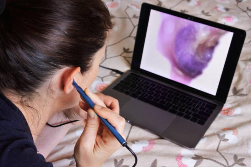 woman using endoscope visual ear cleaner - ear endoscope stock pictures, royalty-free photos &amp; images