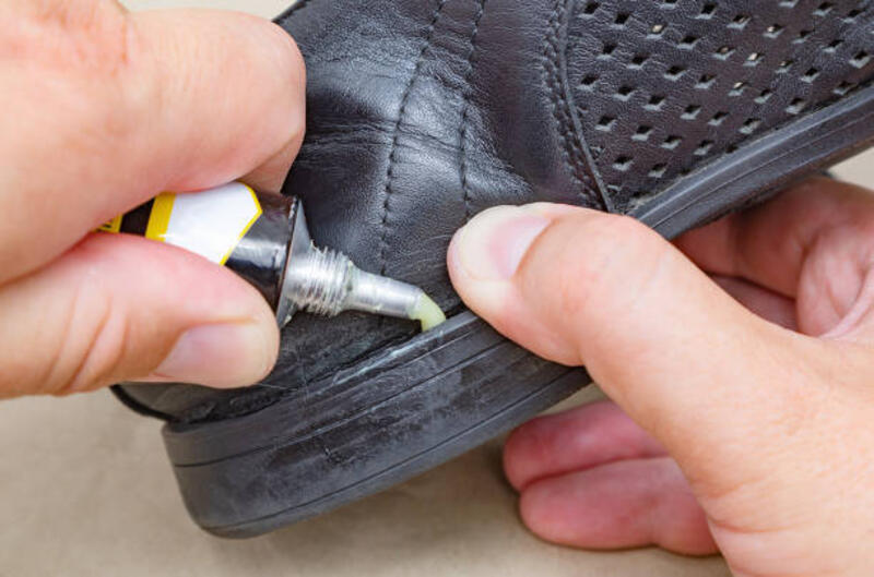 Caucasian poor man repairs leather shoe with glue Lack of money for new shoes gluing shoes stock pictures, royalty-free photos &amp; images