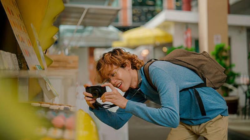 young-asian-man-taking-pictures-of-sold-items-on-a-market-stall-while-going-to-a-retail-space.jpg (612×344)