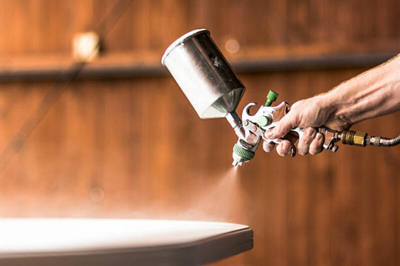 Painting table on white color Painter painting  table on white color. spray gun stock pictures, royalty-free photos &amp; images