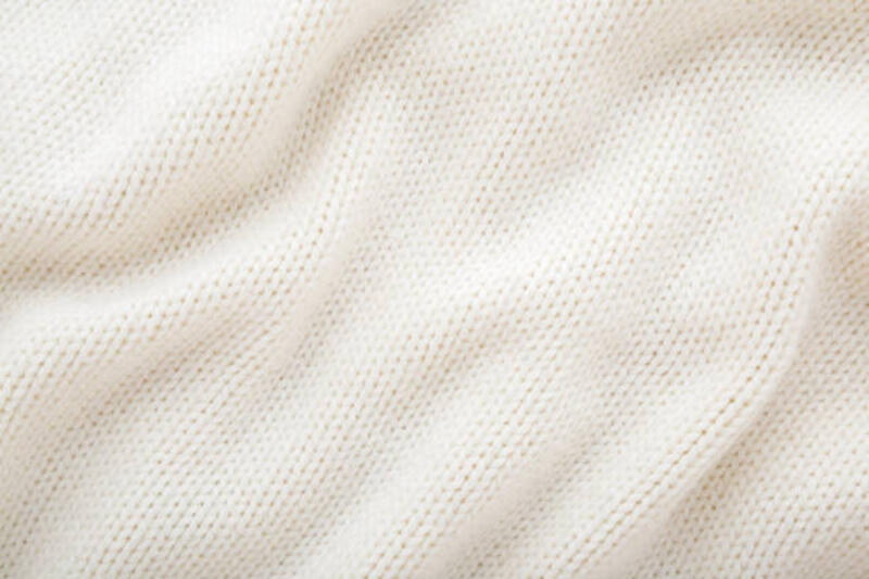 light white wavy soft knitted fabric background. closeup. top down view. - knitwear potret stok, foto, &amp; gambar bebas royalti