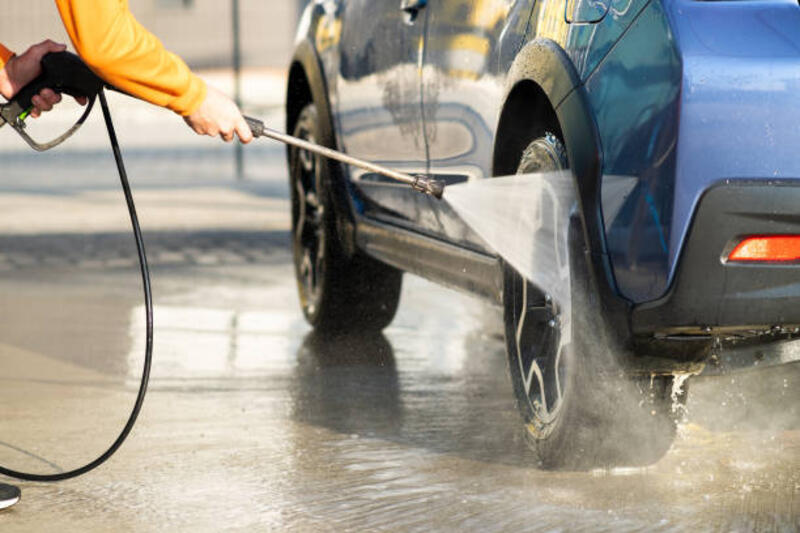 Closeup of male driver washing his car with contactless high pressure water jet in self service car wash. Closeup of male driver washing his car with contactless high pressure water jet in self service car wash. repairing jet cleaner stock pictures, royalty-free photos &amp; images