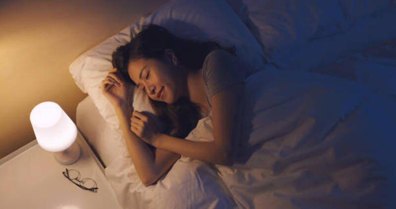 Asian woman sleep well Asian woman sleep well on the bed at night night lamp stock pictures, royalty-free photos &amp; images