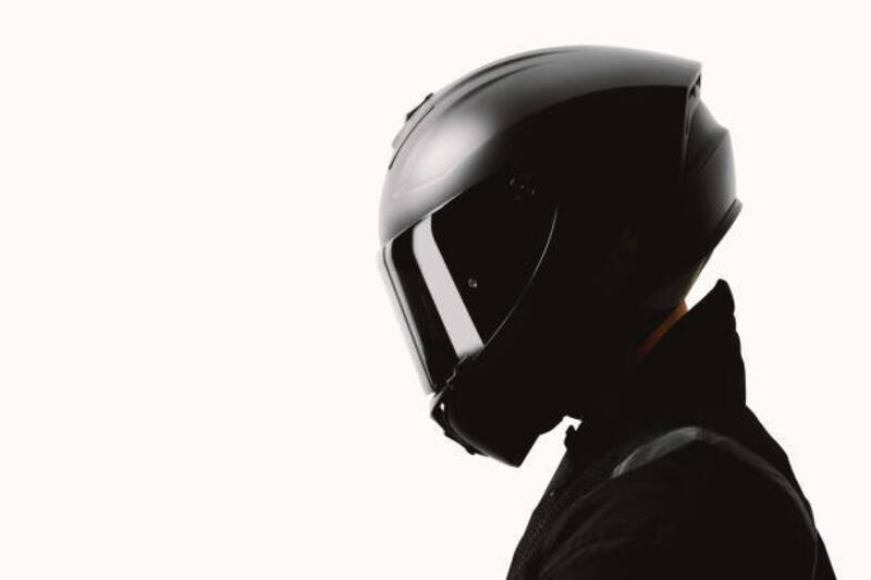 Portrait of a motorcycle rider posing with a black helmet on a white background. Portrait of a motorcycle rider posing with a black helmet on a white background. helmet stock pictures, royalty-free photos &amp; images