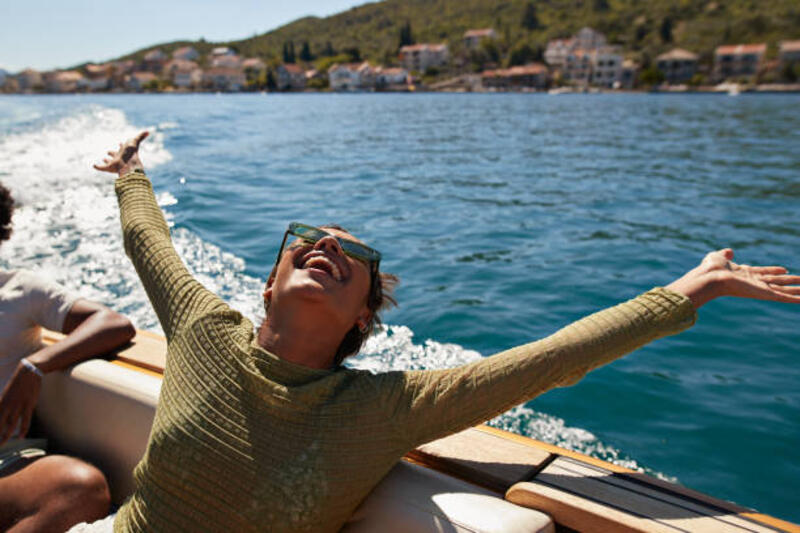 happy-woman-with-arms-raised-in-motorboat.jpg (612×408)