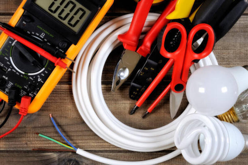 Top view of work tools and electrical system components on antique wooden background. Tester, work tools and electrical equipment on an antique wooden desk. installing strip light stock pictures, royalty-free photos & images