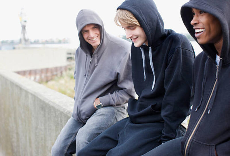 three young men in hoodies sitting on wall - black hoodie potret stok, foto, &amp; gambar bebas royalti