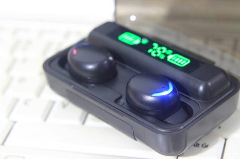 TWS or True Wireless Stereo at White Notebook TWS or True Wireless Stereo at White Notebook tws earphone stock pictures, royalty-free photos &amp; images