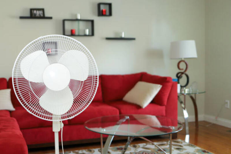 A standing revolving fan in a living room A standing revolving fan in a living room standing fan stock pictures, royalty-free photos &amp; images