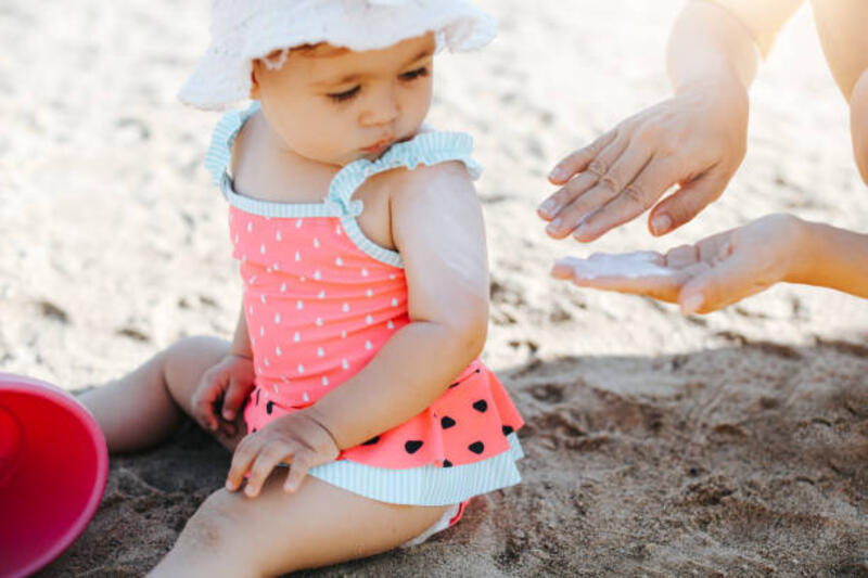 Happy laughing toddler girl having fun on sand Happy laughing toddler girl having fun on sand sunscreen kids stock pictures, royalty-free photos &amp; images