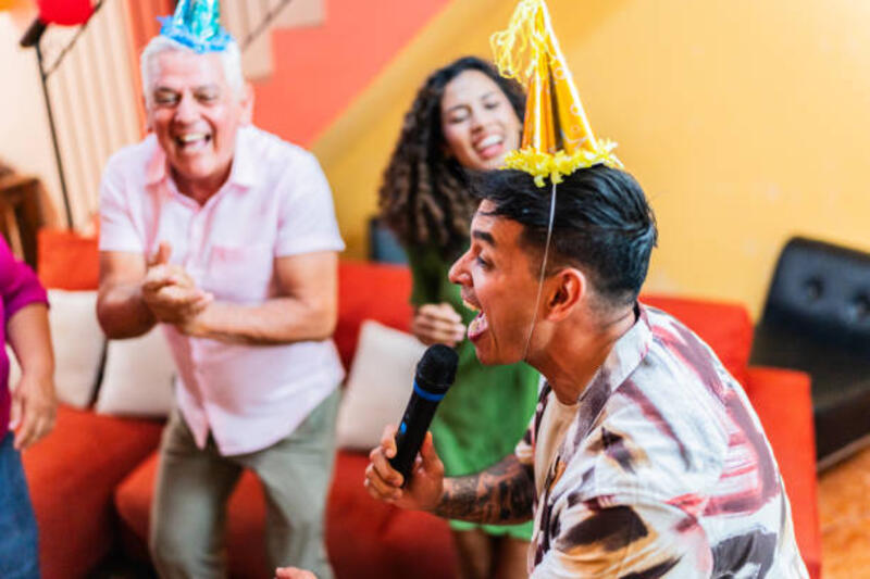 mid-adult-man-singing-on-microphone-and-celebrating-with-family-on-birthday-party-at-home.jpg (612×408)