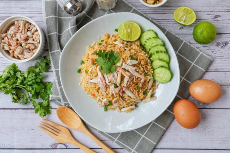 crab fried rice with cucumber and lime on white plate , home made, top view food table - fried rice potret stok, foto, & gambar bebas royalti