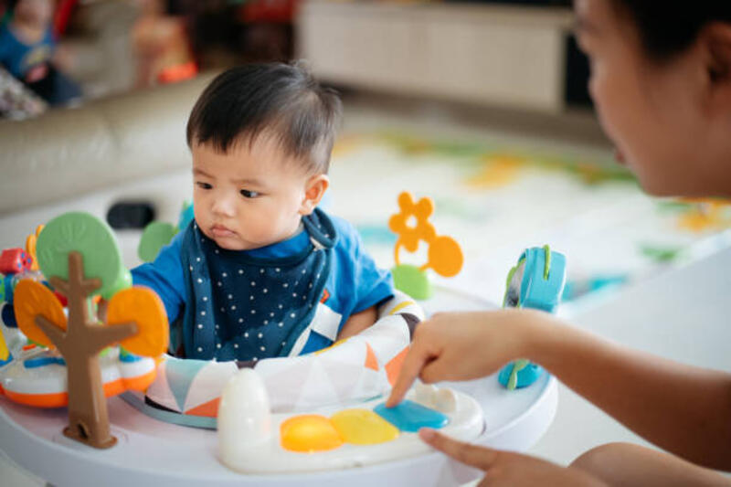 Asian baby boy playing toys together with mother at home Asian baby boy playing toys together with mother on the baby activity centre baby walker stock pictures, royalty-free photos &amp; images