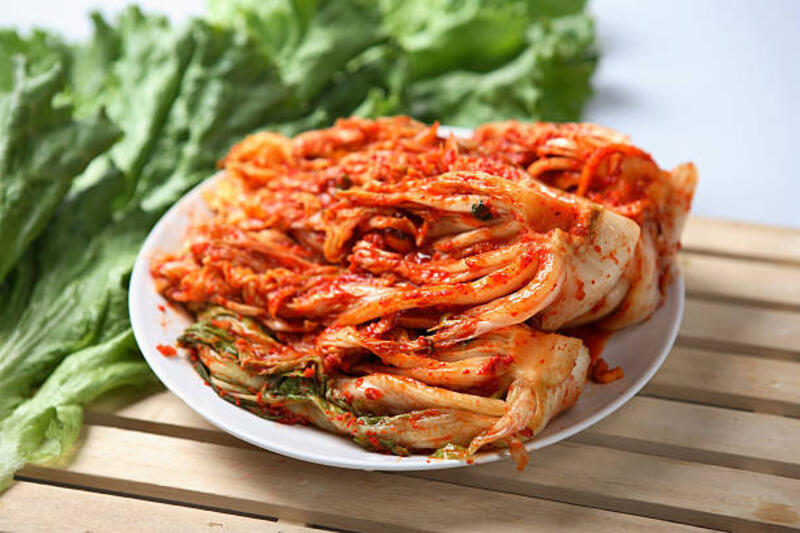 Kimchi dish served on a white plate Spicy Korean Kimchee kimchi stock pictures, royalty-free photos &amp; images