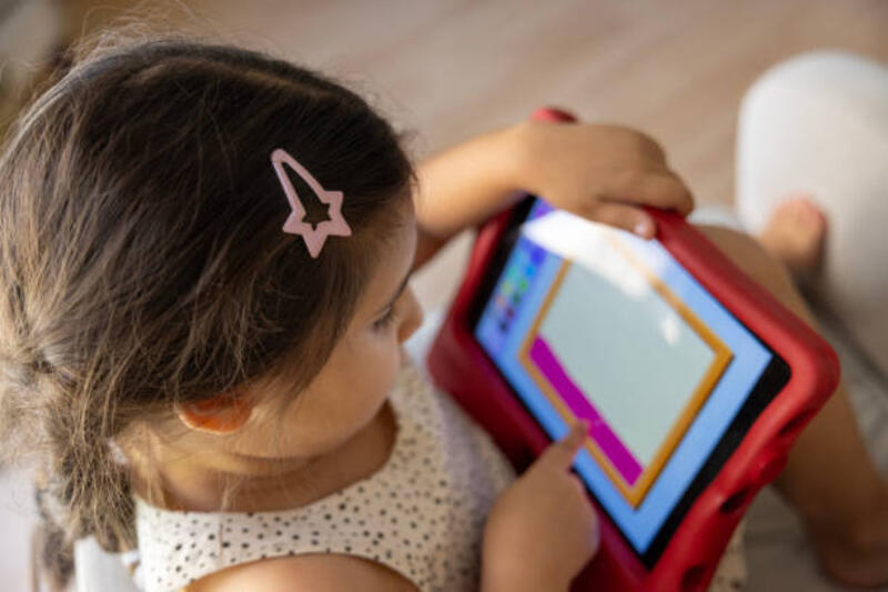 a-little-girl-playing-with-a-tablet-on-the-couch.jpg (612×408)