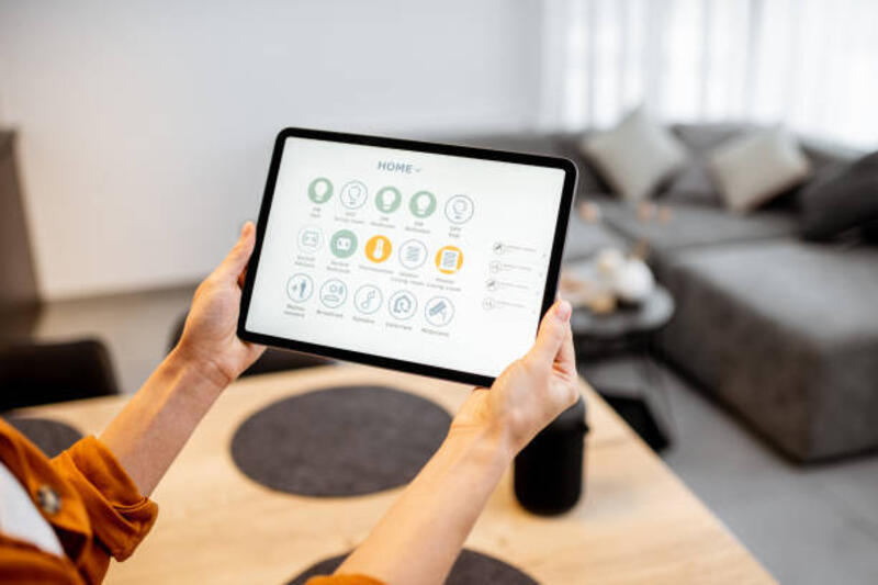 Woman controlling smart devices with a digital tablet at home Young woman controlling home with a digital touch screen panel. Concept of a smart home and mobile application for managing smart devices at home. Close-up on a hands and tablet smart remote control stock pictures, royalty-free photos & images