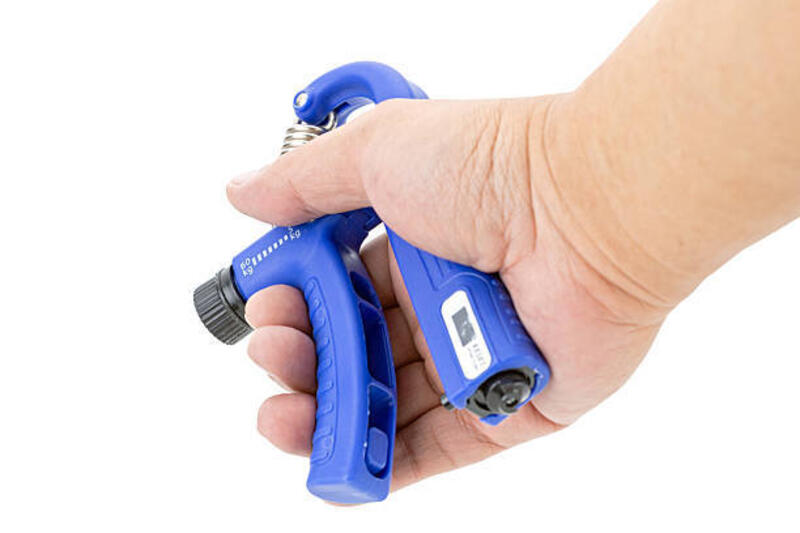 adjustable weighted hand squeezing exercise equipment isolated on white. - handgrip potret stok, foto, &amp; gambar bebas royalti