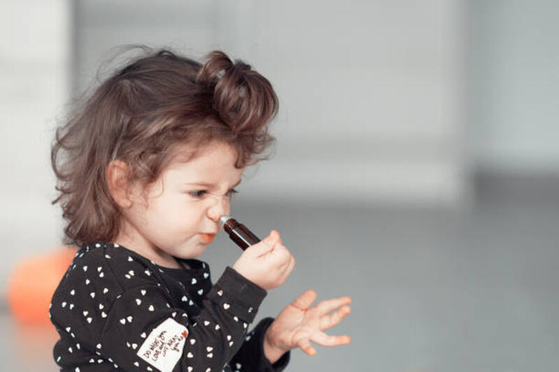 Being silly with essential oils Little baby girl playing with essential oils inside the house, frowning essential oil kid stock pictures, royalty-free photos &amp; images