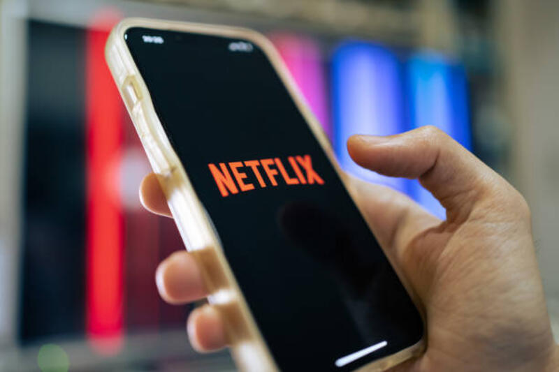 Netflix Bangkok, Thailand - April 25, 2022 : iPhone 13 showing its screen with Netflix application. watching phone screen stock pictures, royalty-free photos & images